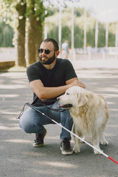 istock Blind man with guide dog in a summer city 1280022992