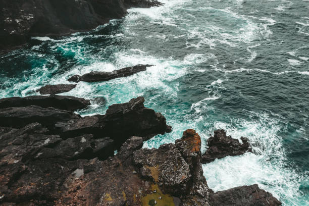 Aerial view of the coastline and cliffs at Eshaness on the Atlantic coast of the Shetland Islands. Foggy rainy day.