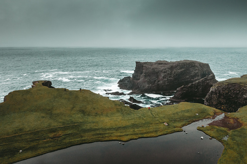 Aerial view of the coastline and cliffs at Eshaness on the Atlantic coast of the Shetland Islands. Foggy rainy day.
