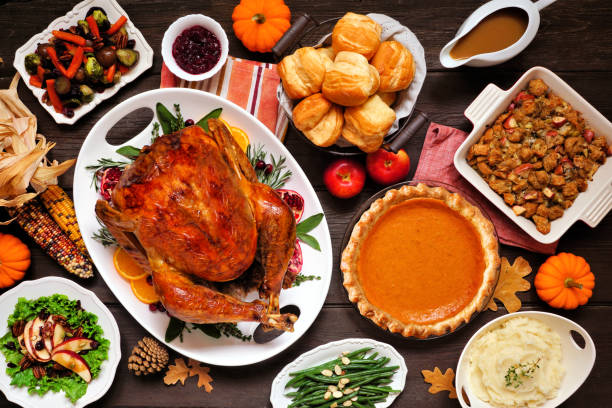 istock Classic Thanksgiving turkey dinner. Above view table scene on a dark wood background. 1280027278