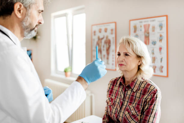Doctor Doing an Eye Exam on His Senior Patient