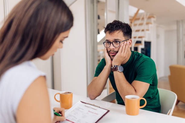 istock Young man trying to solve his problems with the help of a psychotherapist 1280028626