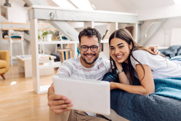 istock Happy couple surfing the net and enjoying at home 1280028721