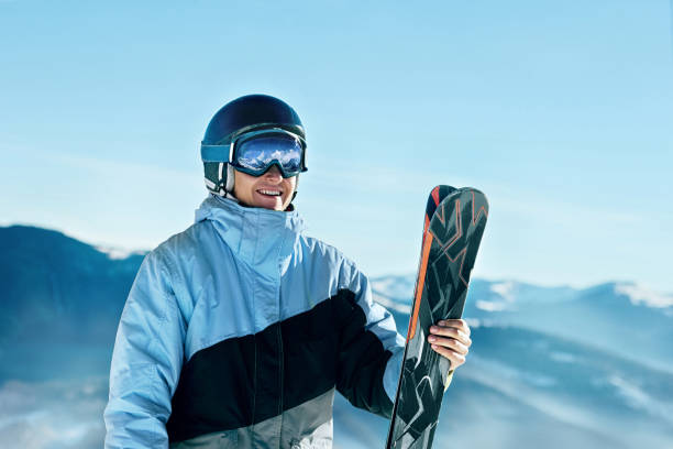 Portrait of a skier in the ski resort on the background of mountains and blue sky, Bukovel.  Ski goggles of a man wearing ski glasses. Winter Sports stock photo