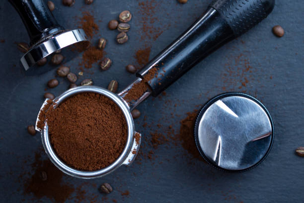istock Portafilter with coffee and temper on table 1280030470