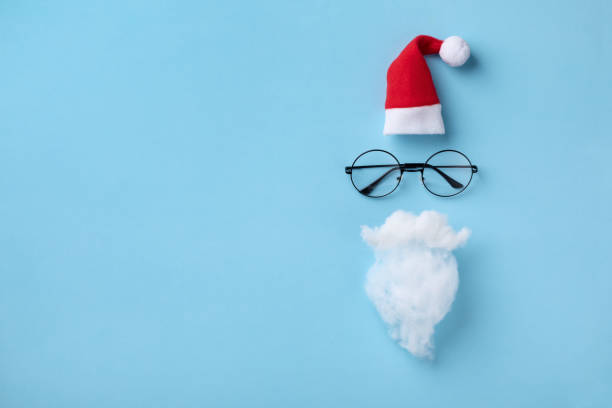 istock Creative Christmas composition. Greeting card, invitation or flyer. Santa hat, beard and glasses on blue background. 1280031623