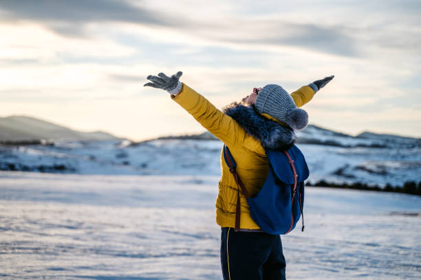 istock Woman with open arms in a winter sunset 1280031689