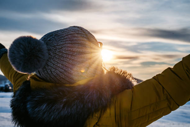 istock Woman with open arms in a winter sunset 1280031743