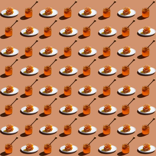 istock Seamless pattern with jar of honey and sweet honeycomb. 1280032027