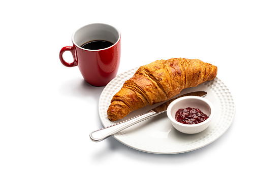 continental breakfast, .coffee ,croissant and Marmalade on a white plate , isolated on white.