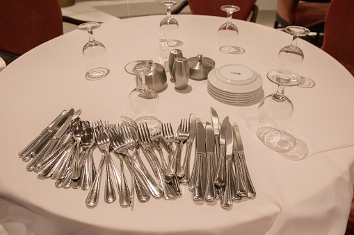 Silverware on a table ready to be used to set tables.
