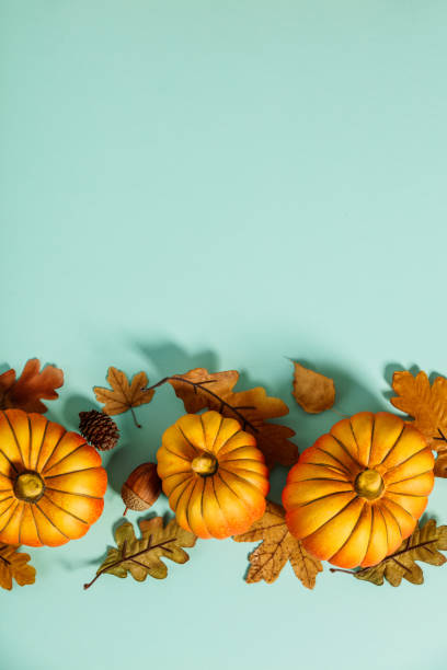 istock Autumn background creative layout with decorative small pumpkins and autumn leaves 1280033380