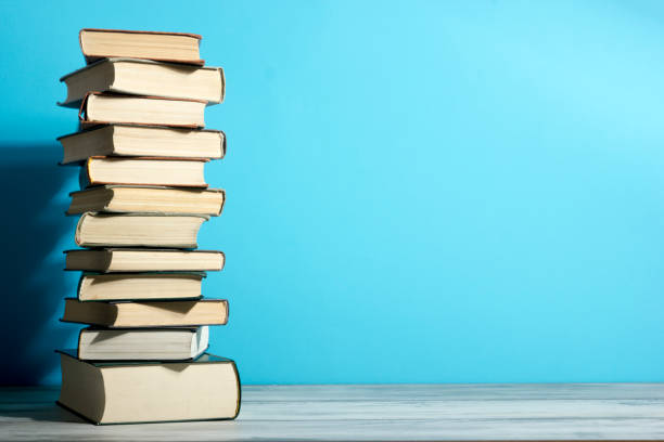 istock Open book, hardback books on wooden table. Back to school. Copy space. 1280035461