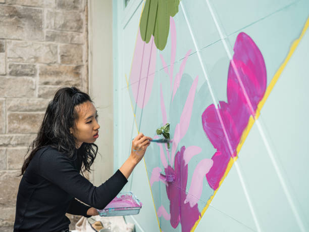 istock Female mural artist at work 1280037379