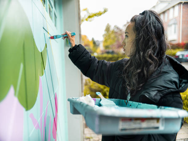 istock Female mural artist at work 1280037424