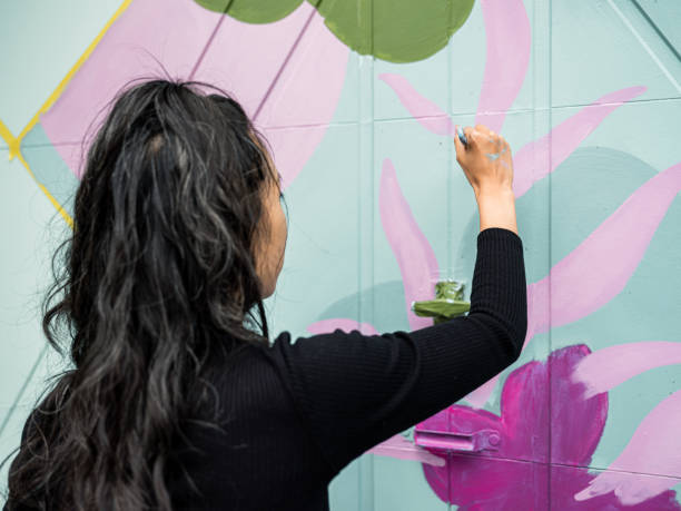 istock Female mural artist at work 1280037431