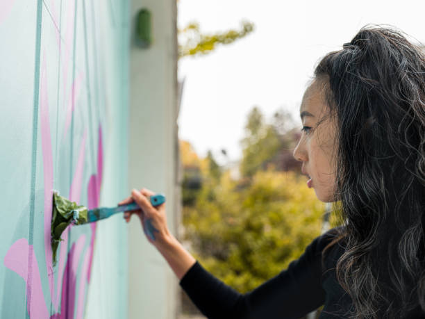 istock Female mural artist at work 1280038166