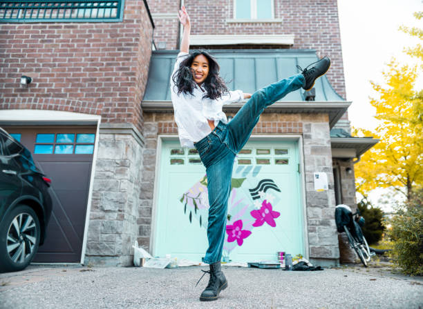 Female mural artist dancing