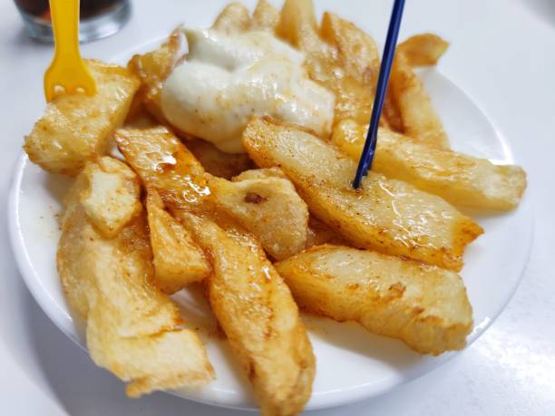 istock typical Spanish potatoes bravas and a cola, typical Spanish spicy potatoes,served in a bar in Barcelona, Catalonia, Spain 1280038828