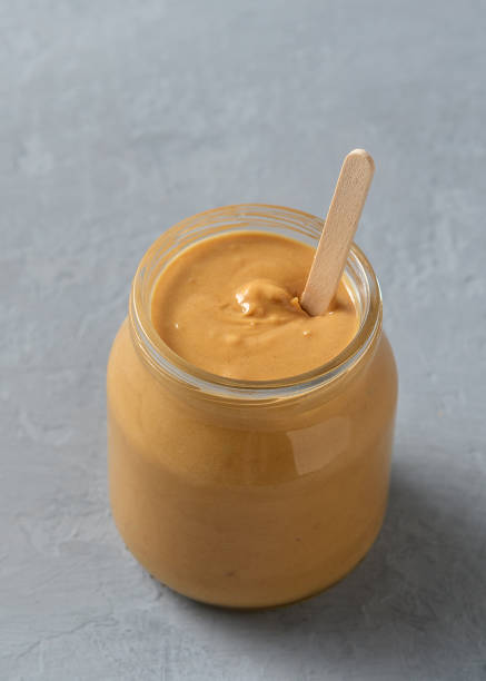 istock Homemade peanut butter in glass jars on concrete surface. 1280038879