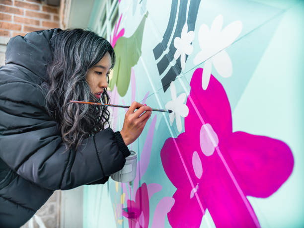 istock Female mural artist at work 1280039538