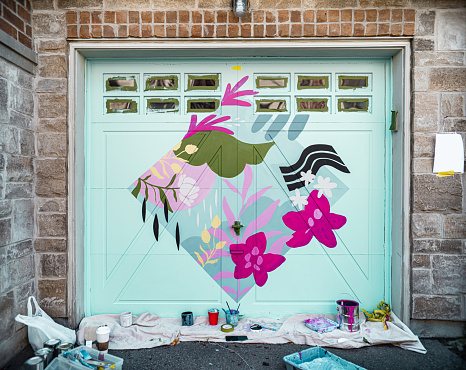 Mural art on the garage door of the private home in the city.