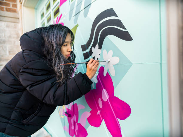 istock Female mural artist at work 1280039544