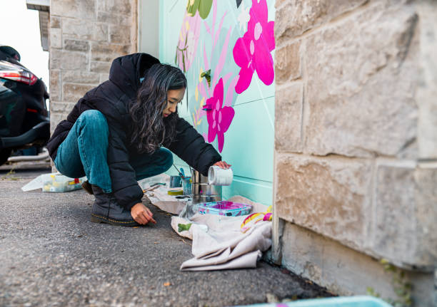 istock Female mural artist at work 1280039587