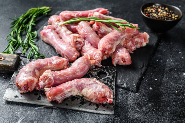 istock Raw Turkey neck meat on a cutting board. Black background. Top view 1280039779