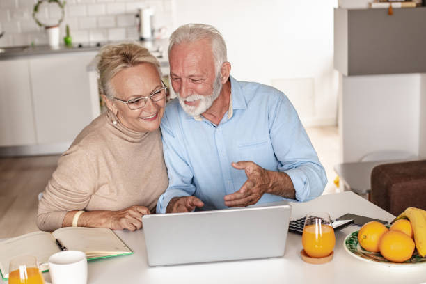 istock Senior couple using laptop at home 1280041413