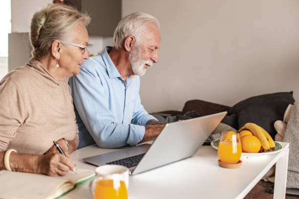 istock Senior couple using laptop at home 1280041509