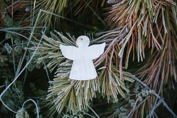 istock Wooden decoration angel white figure in spruce branches 1280041662