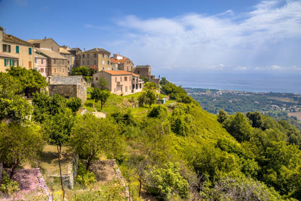 Mountain Village Corsica Mountain Village of San-nicolao with view over the mediteranean sea on Corsica, France corsican flag stock pictures, royalty-free photos & images