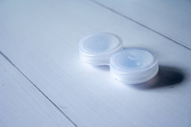 istock Containers for contact lenses on wooden table background 1280045091