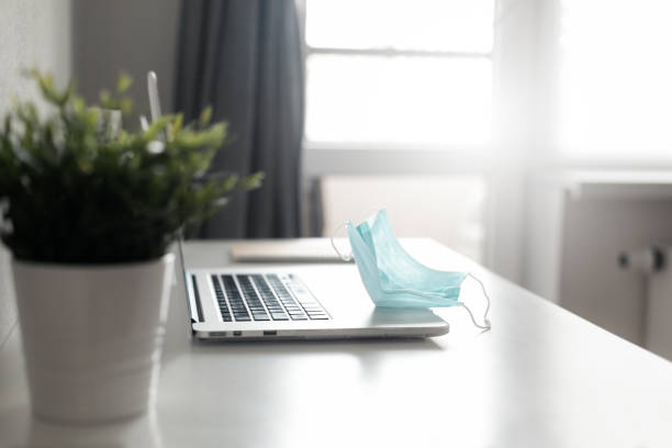 istock Medical protective mask on laptop,  Covid-19 concept, nobody 1280045862