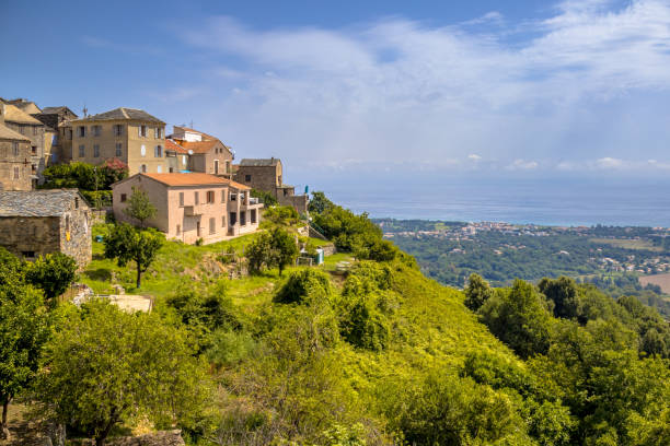Mountain Village Corsica Mountain Village of San-nicolao with view over the mediteranean sea on Corsica, France corsican flag stock pictures, royalty-free photos & images