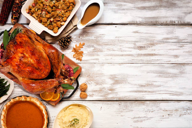 Traditional Thanksgiving turkey dinner. Top view side border on a rustic white wood background. Traditional Thanksgiving turkey dinner. Top view side border on a rustic white wood background with copy space. Turkey, stuffing, mashed potatoes and pumpkin pie. gravy stock pictures, royalty-free photos & images
