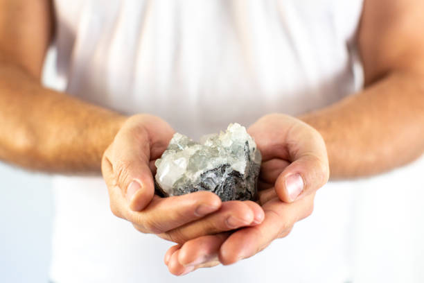 istock Man's hand holds a rock crystal 1280047161