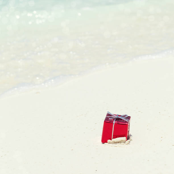 istock Packed gifts on sand with azur sea background 1280047536