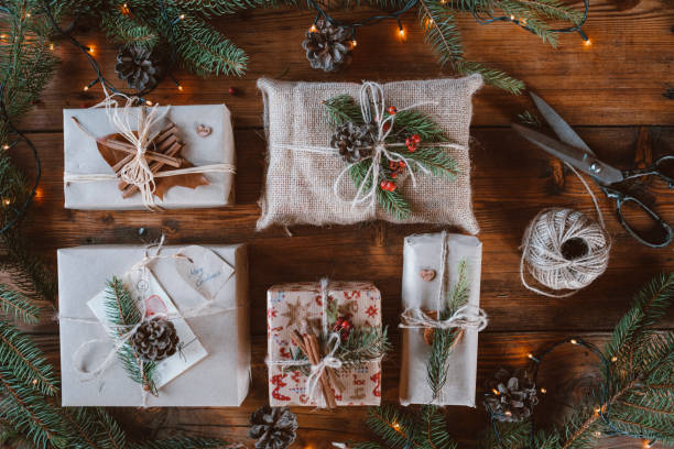 istock Wrapped Christmas presents on wooden table background. 1280047546