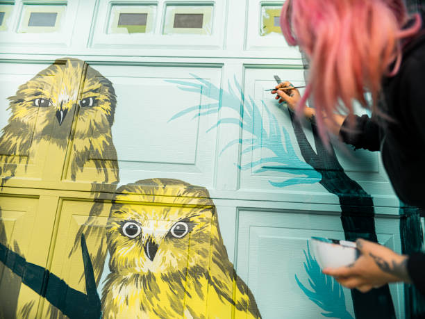 istock Female mural artist at work 1280047711