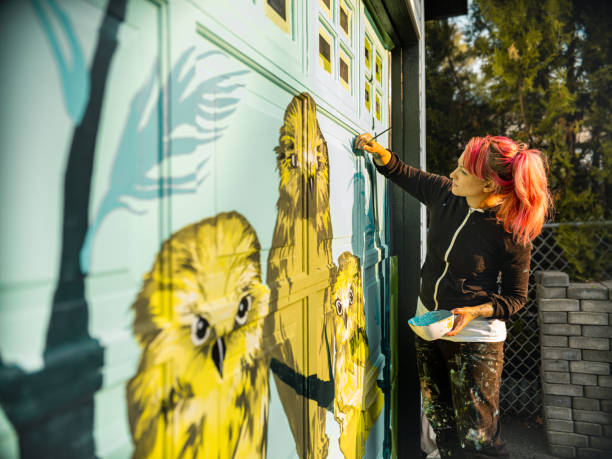 istock Female mural artist at work 1280047712