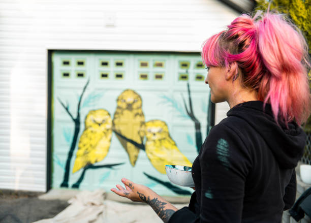 istock Female mural artist at work 1280048276