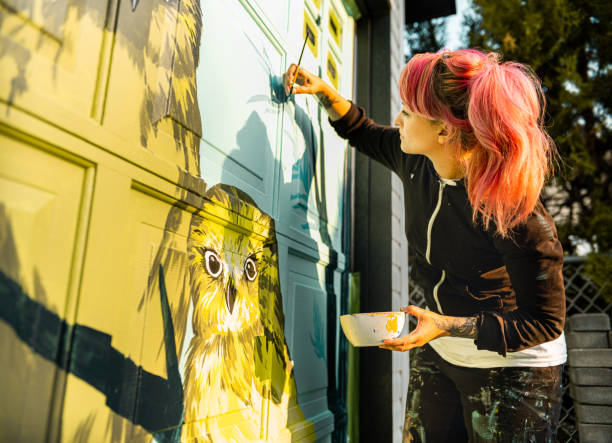 istock Female mural artist at work 1280048278