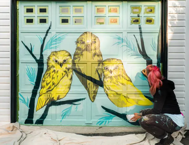 Photo of Female mural artist at work