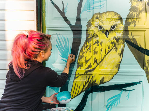 istock Female mural artist at work 1280048386