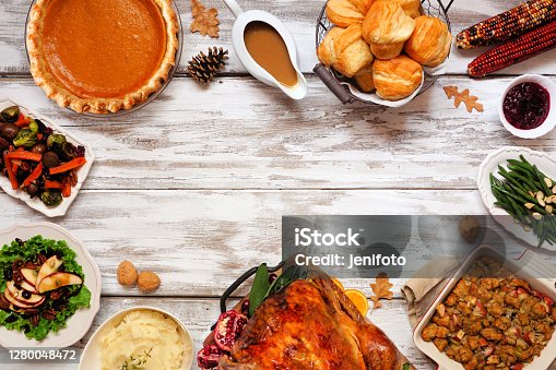 istock Classic Thanksgiving turkey dinner. Top down view frame on a rustic white wood background. 1280048472