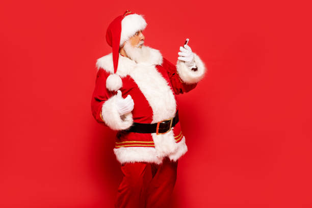 istock Real Santa Claus looking at mobile phone screen 1280049063
