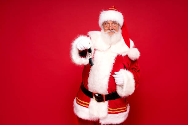 istock Happy Santa Claus with car keys as a gift. 1280049685