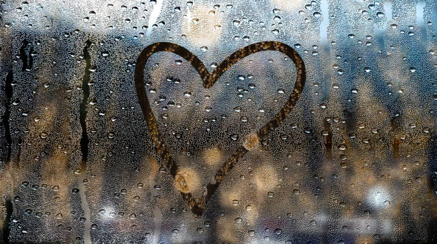 istock heart drawn on a window wet from the rain 1280052223